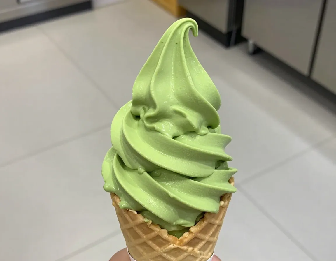 Classic ceremonial matcha soft serve cone with vibrant green swirl