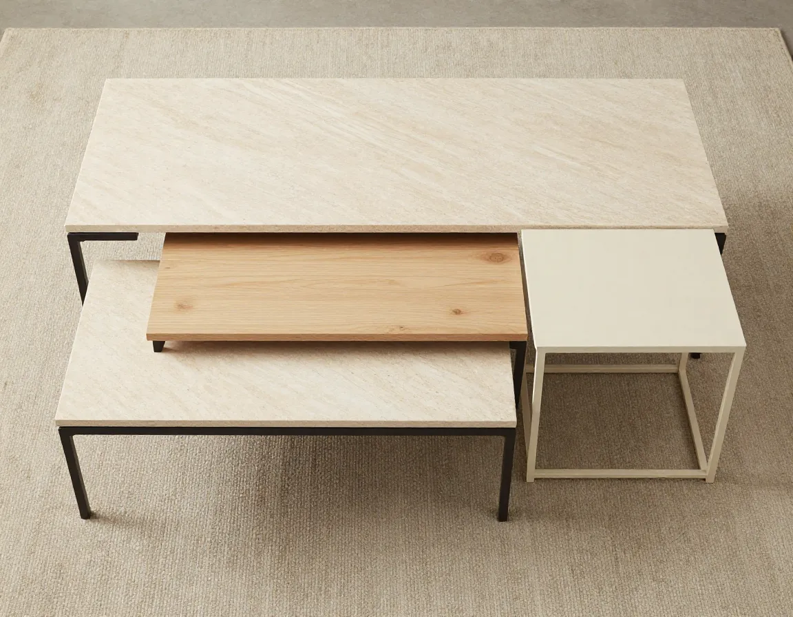 Nested beige coffee tables in mixed materials separated