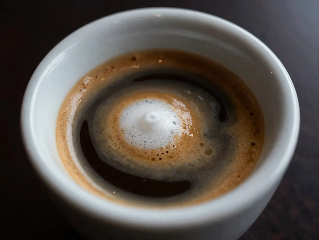 Two shots of espresso with a dollop of white foam