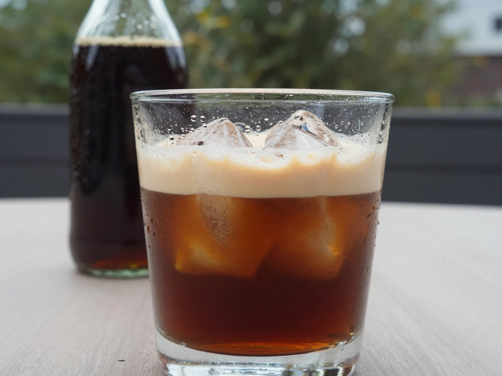 Iced irish coffee with cold brew and ice in rocks glass