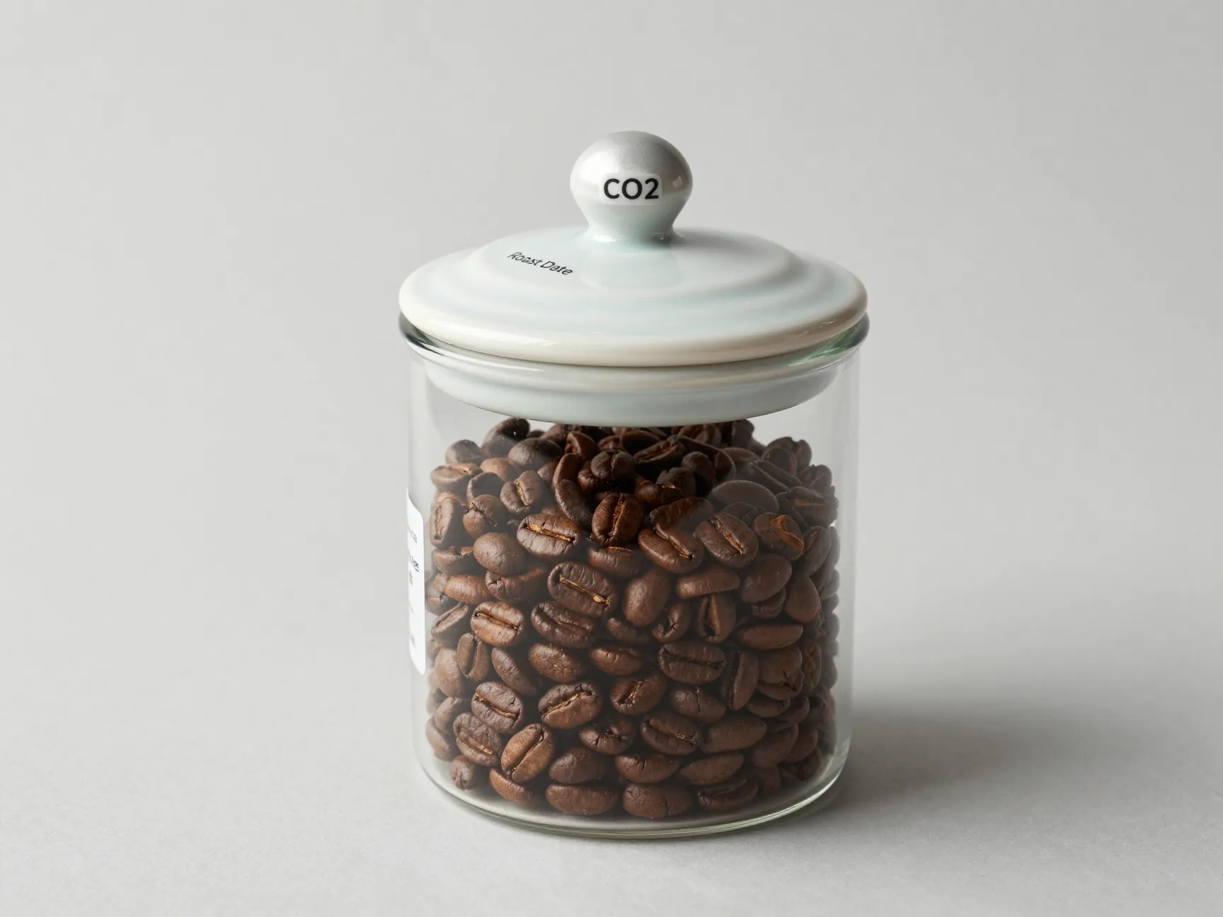Airtight ceramic canister with valve holding rested roasted coffee beans