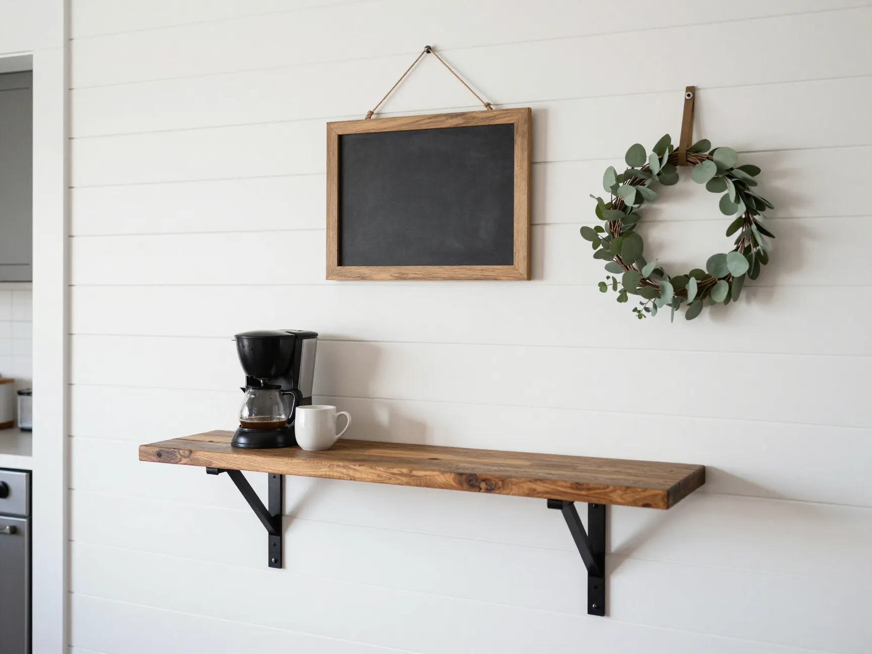 Shiplap accent wall coffee bar with chalkboard sign and black iron brackets