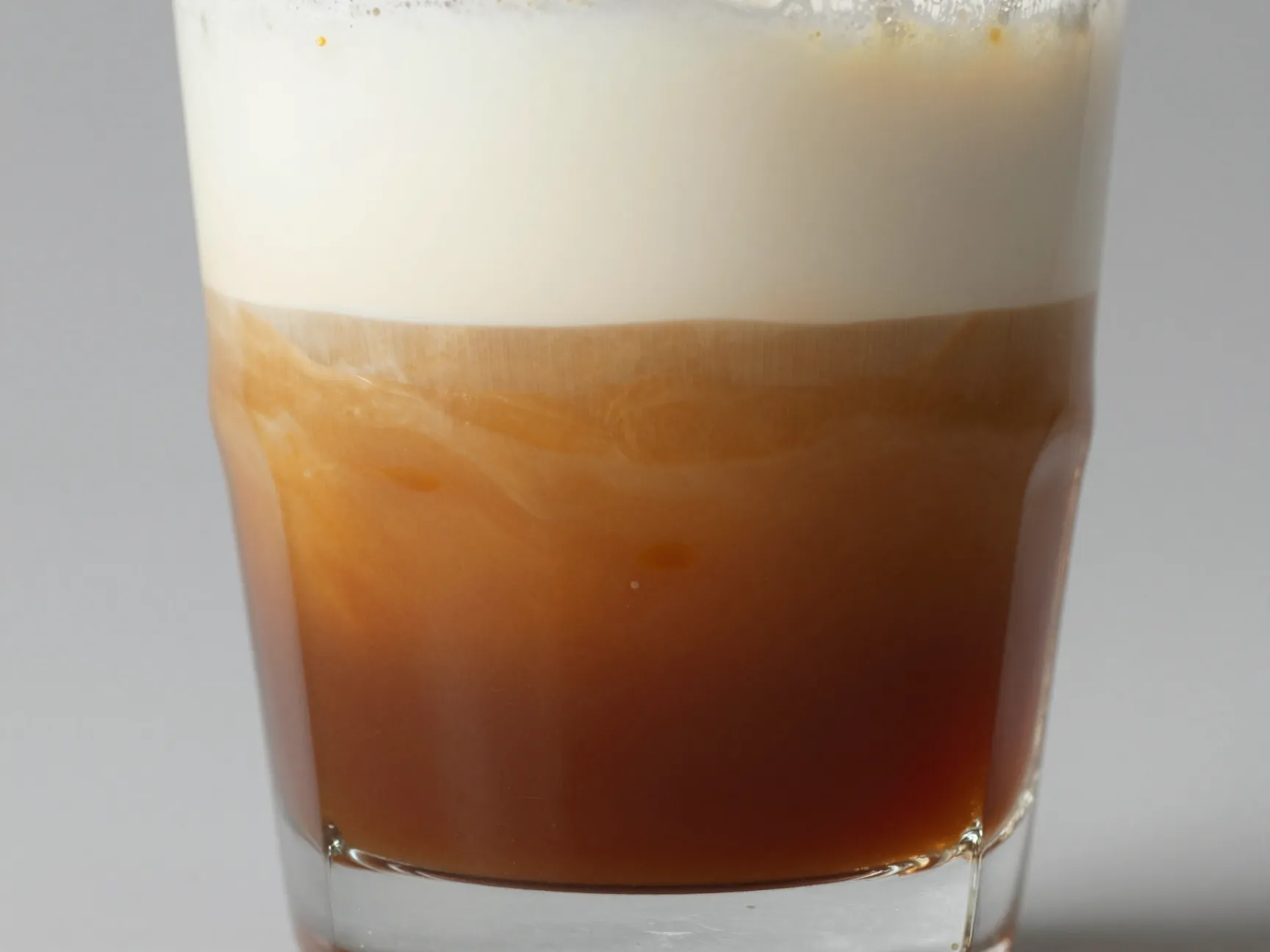 Upside down caramel macchiato with espresso and caramel mixed at bottom