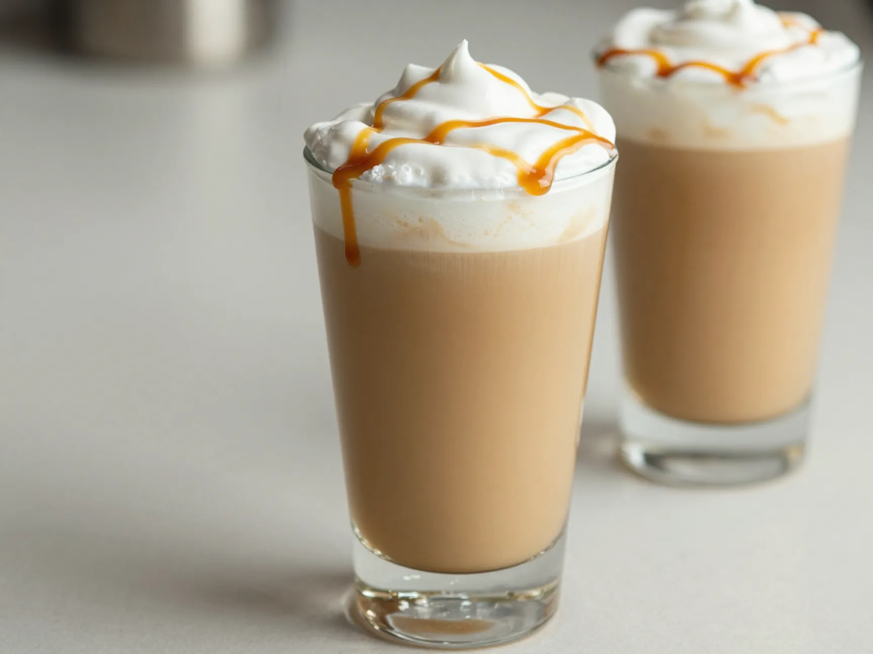Oat milk caramel macchiato in a glass showcasing its creamy texture