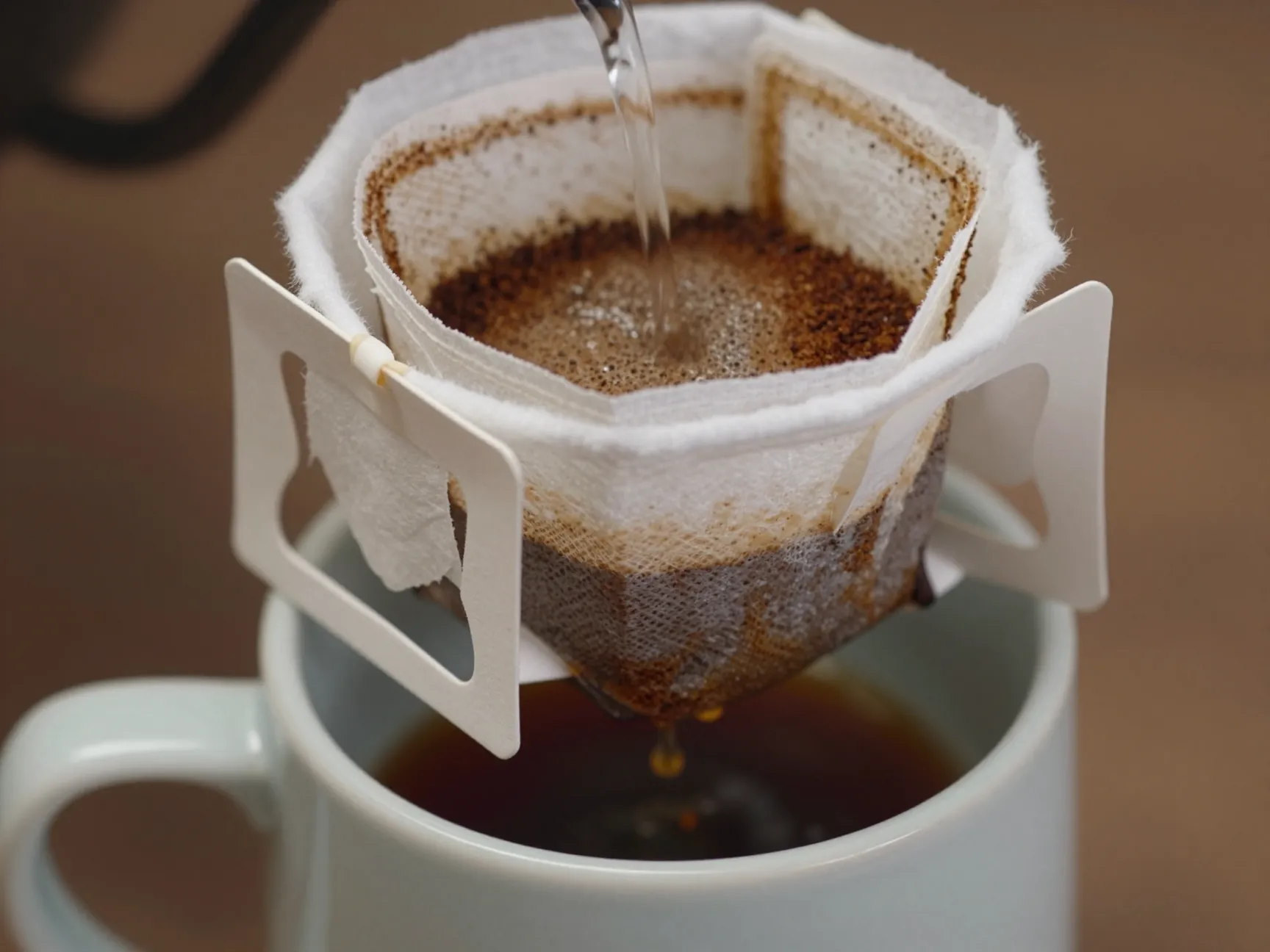 Cloth filter coffee method thin cotton secured over mug