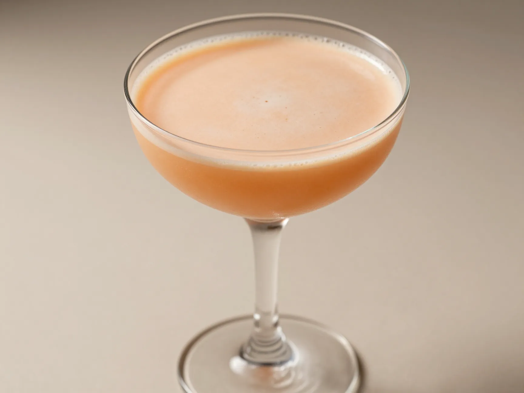 Silky smoked peach espresso martini in chilled coupe