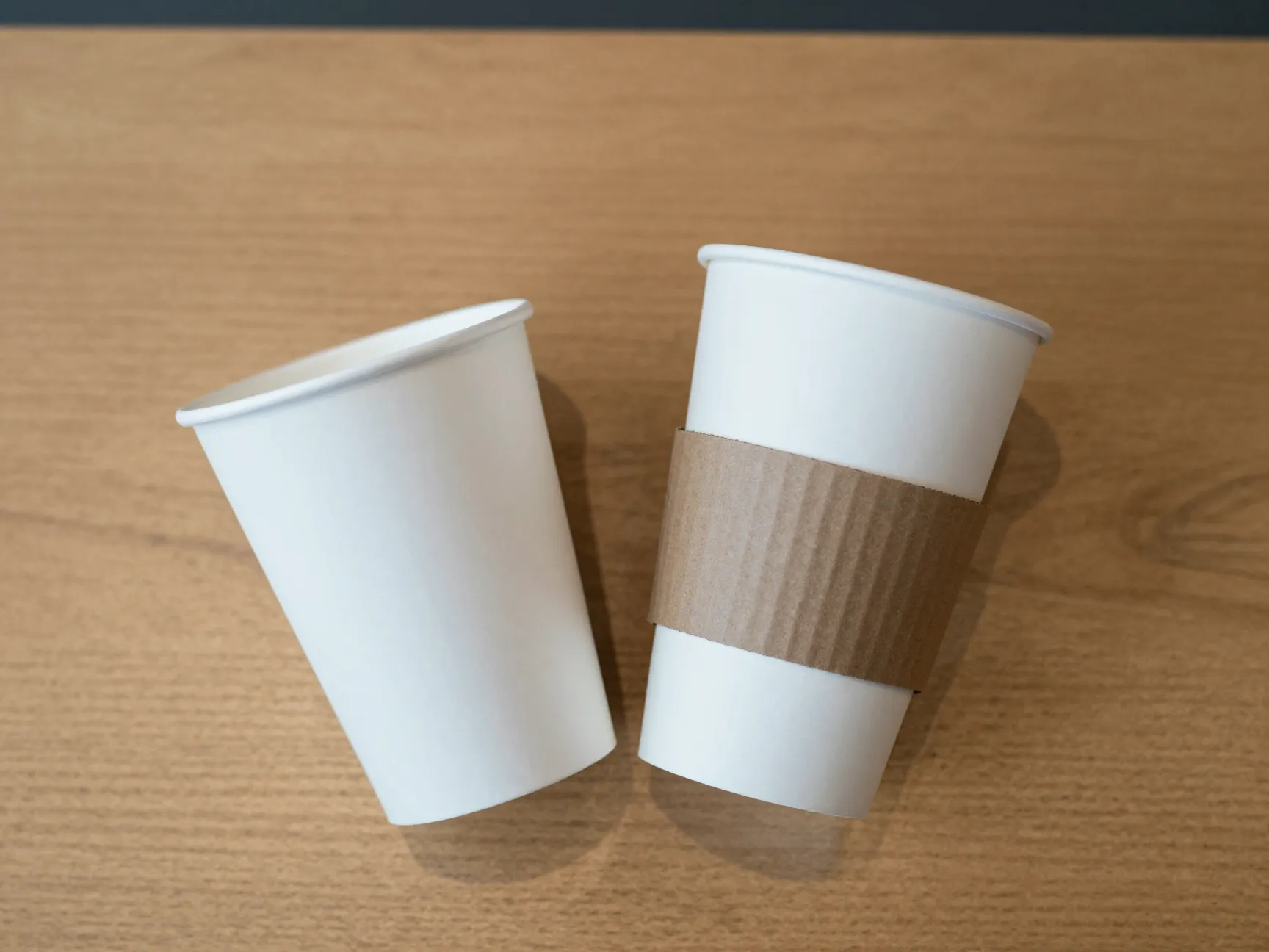 Double cupped paper cup with sleeve on counter