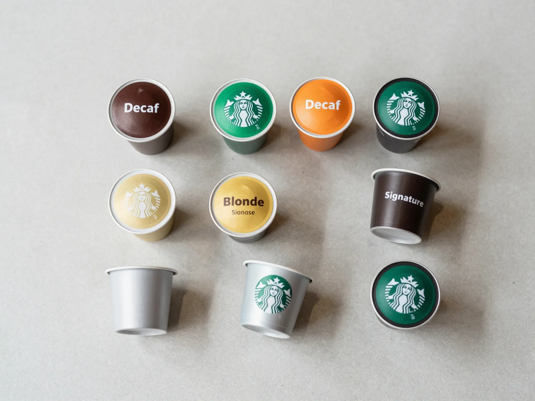 Half caf and decaf espresso pods arranged on counter