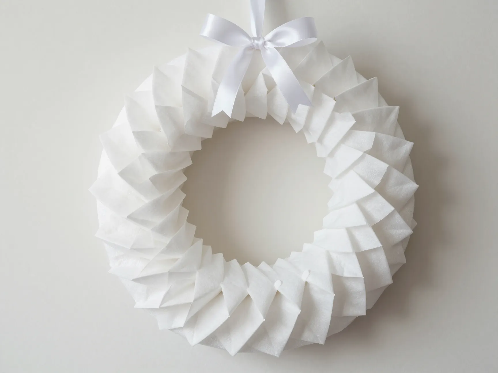 White coffee filter wreath made from folded quartered filters on foam form