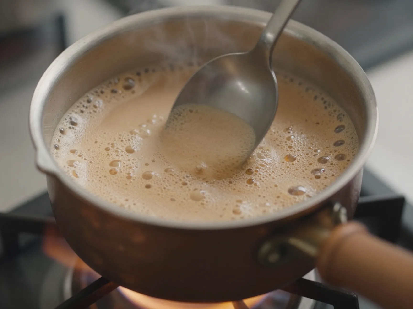 Gentle boil in cezve with spoon stirring foam down