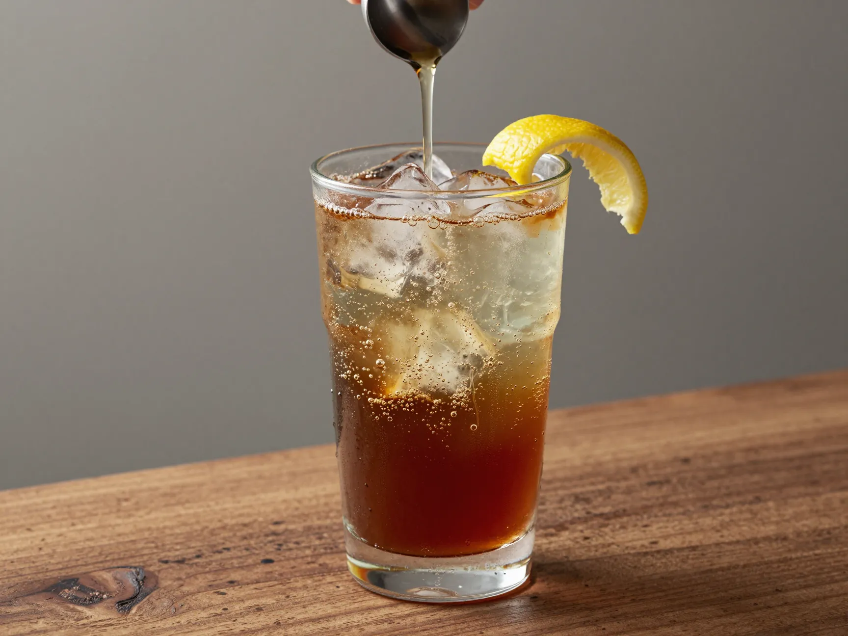 Sparkling iced americano with effervescent bubbles and lemon twist