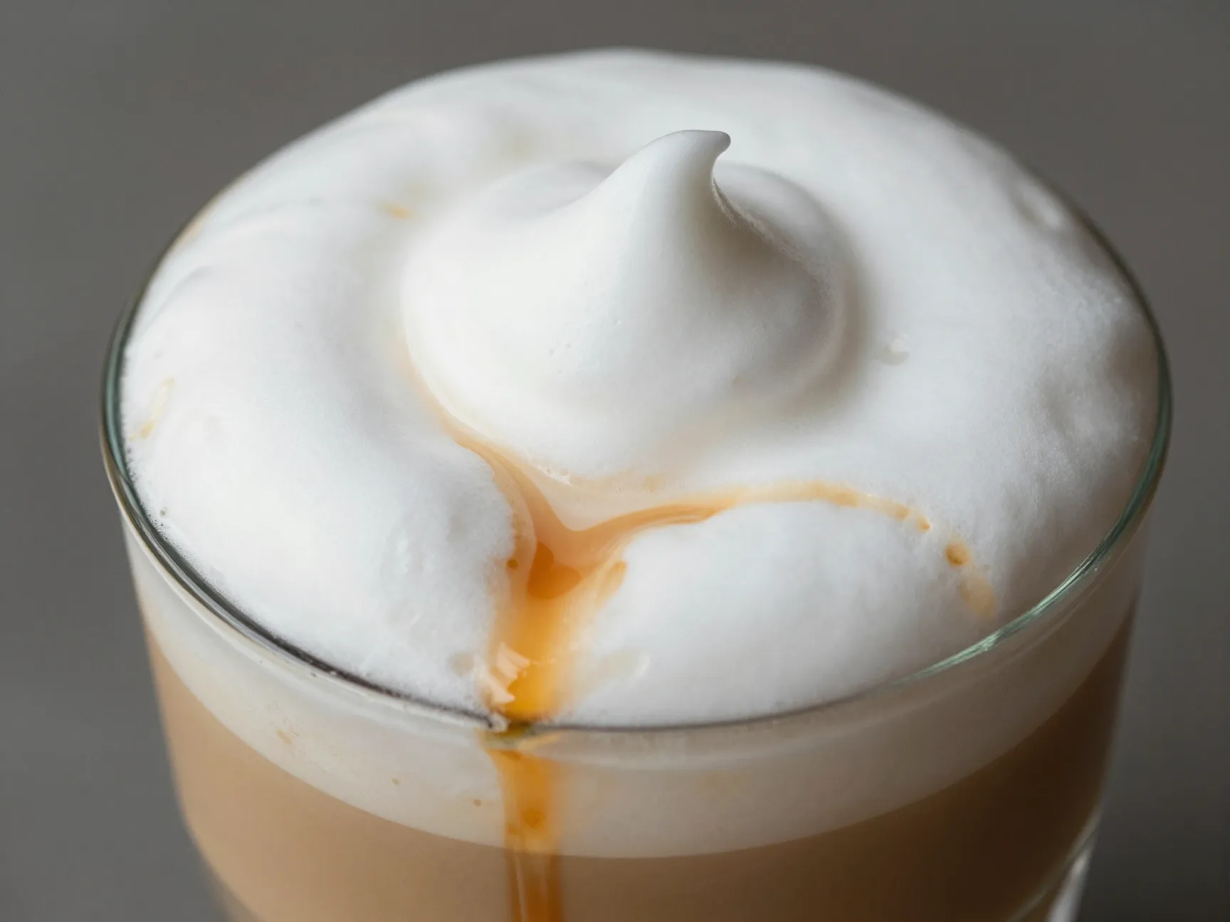 Vanilla sweet cream cold foam topping on caramel macchiato drink