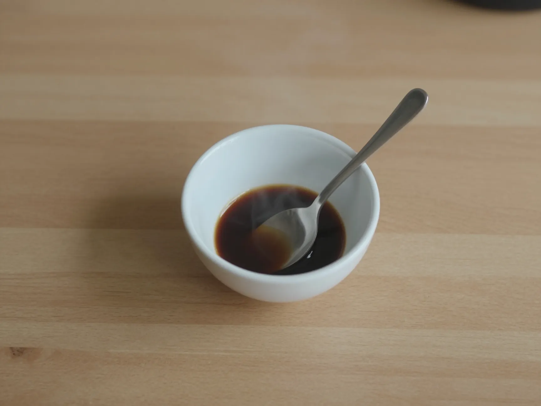 Small bowl of room temperature espresso cooling on counter