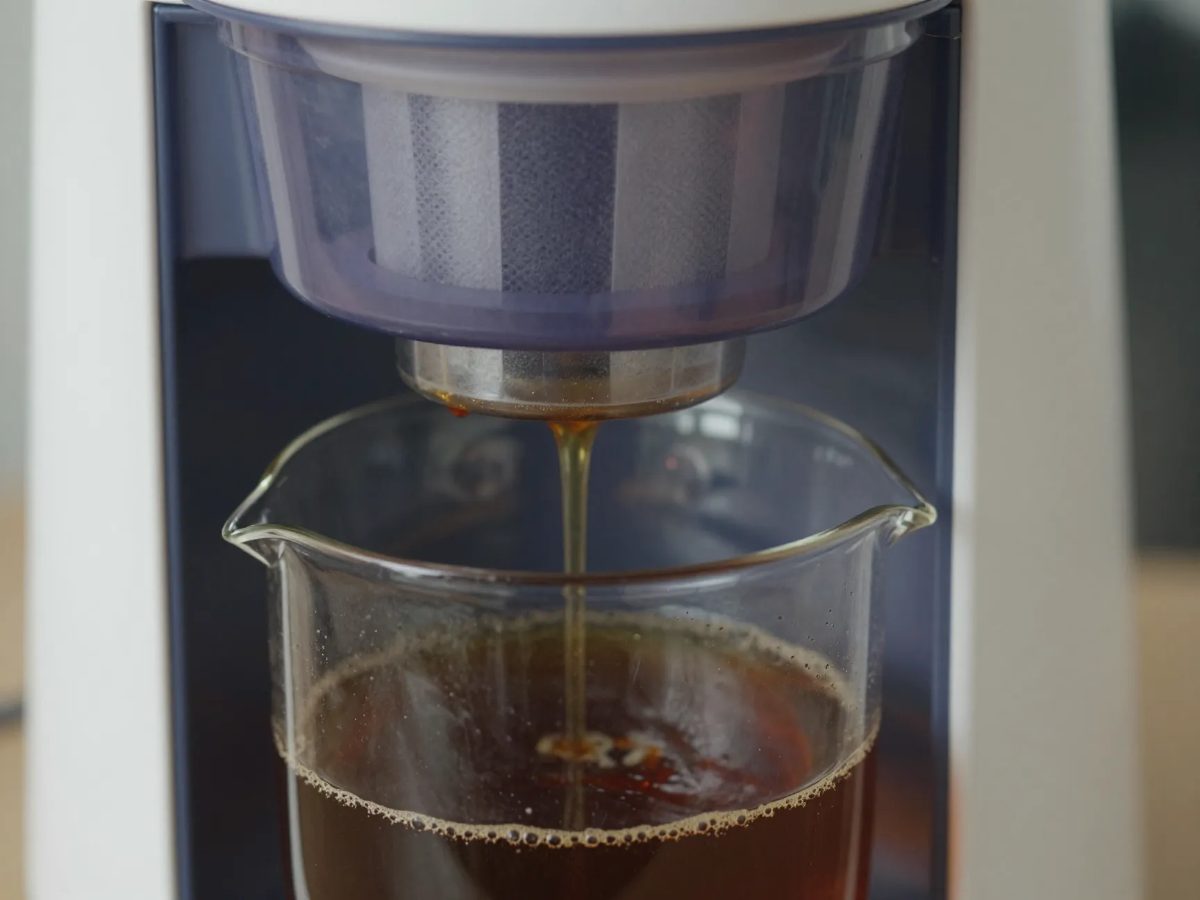 Cold brew coffee maker with concentrate dripping into jug