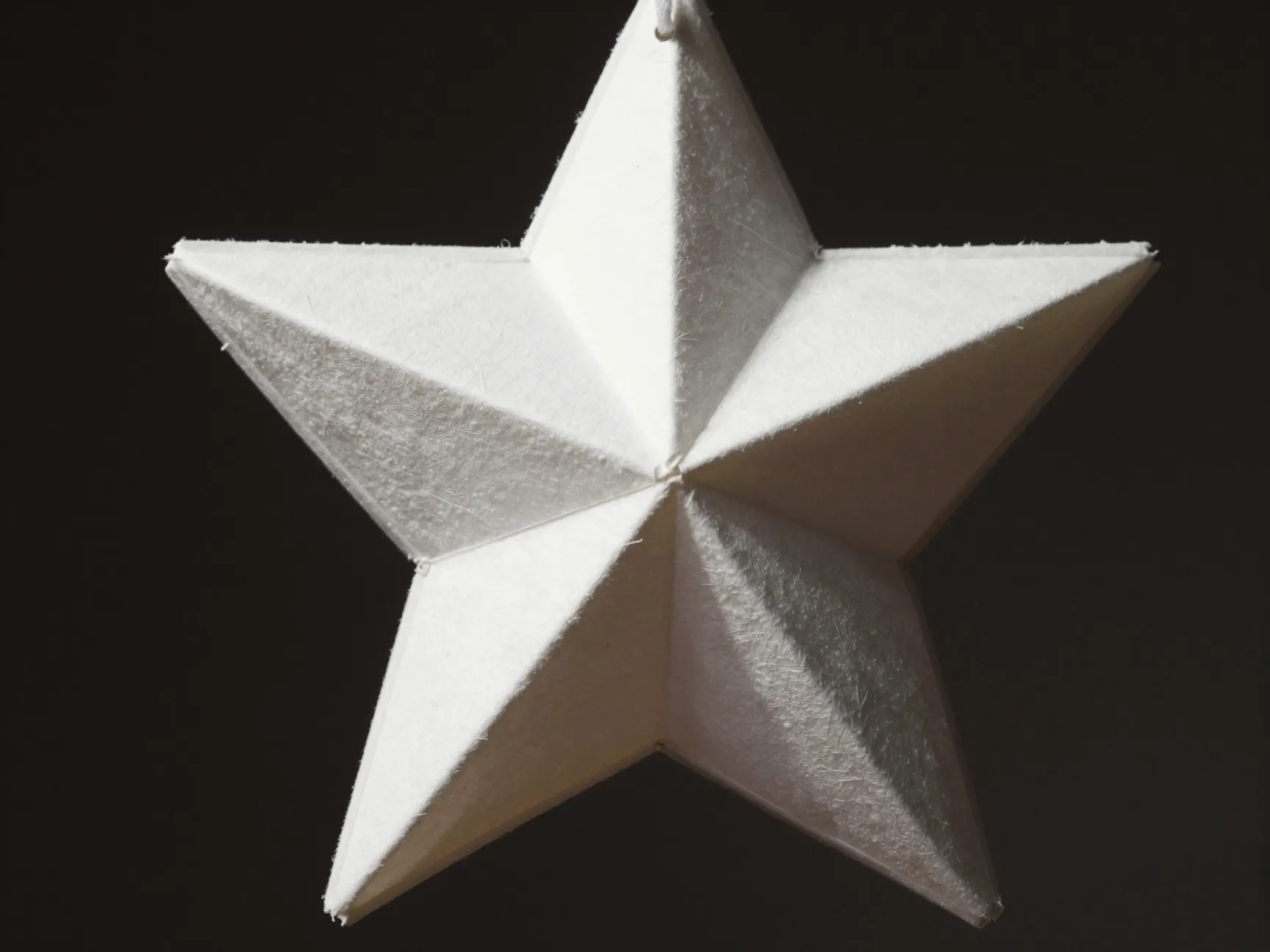 Layered dimensional coffee filter star ornament hanging from string