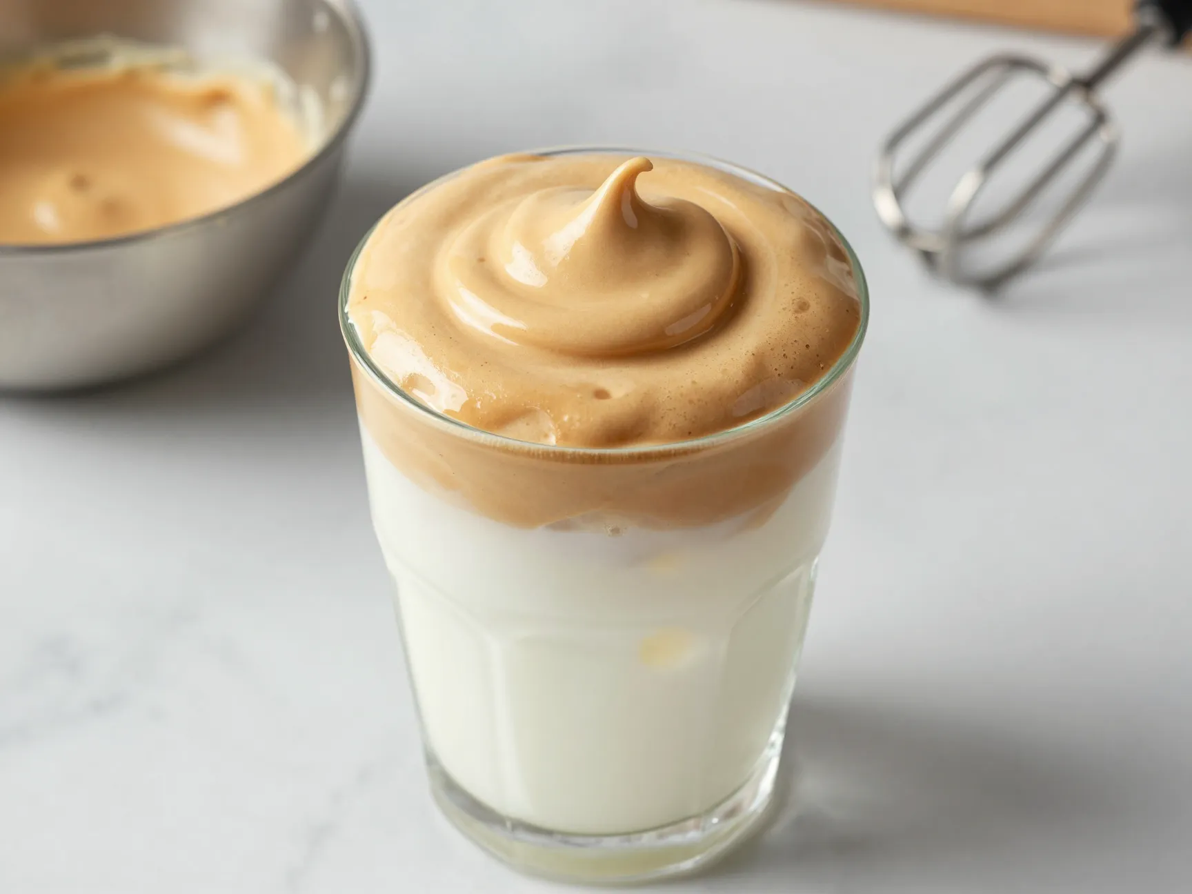 Classic dalgona whipped coffee over iced milk