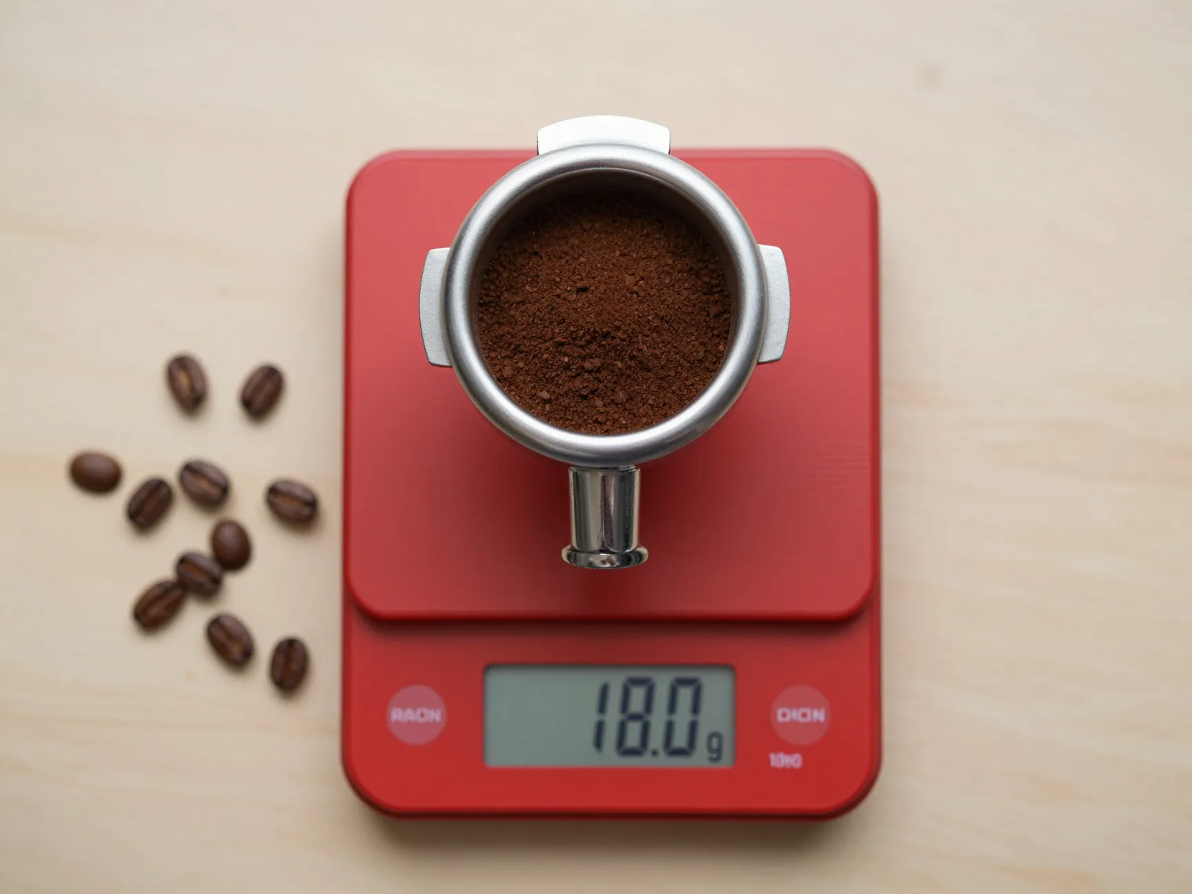 Precision scale weighing 18 grams coffee grounds in portafilter basket