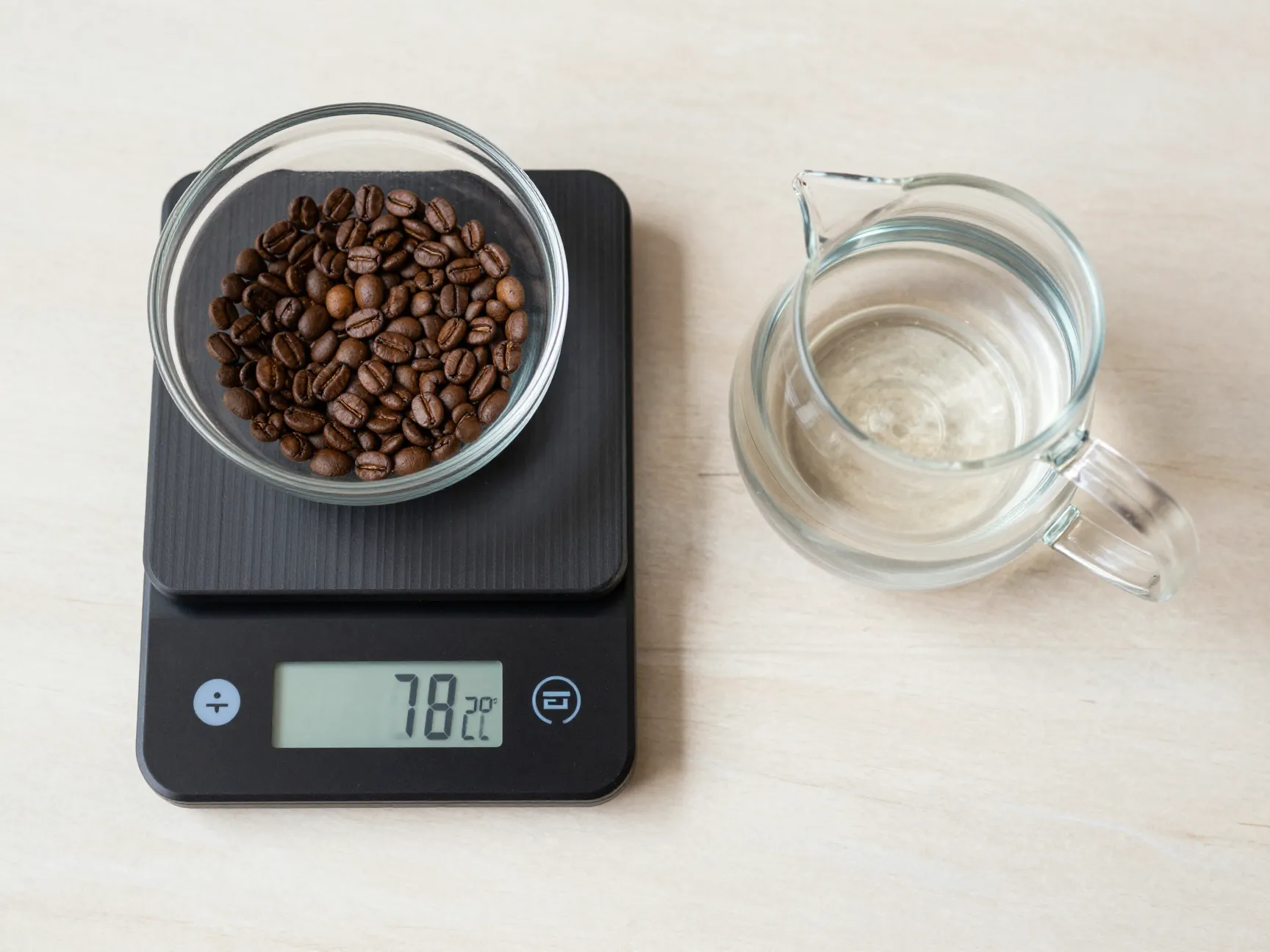 Digital kitchen scale measuring coffee beans and water for perfect ratio
