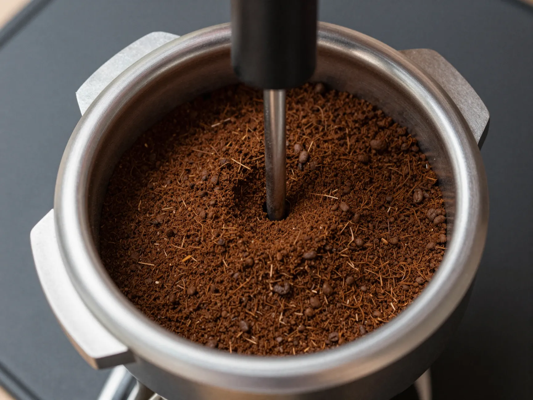 Wdt tool distributing coffee grounds in portafilter before tamping