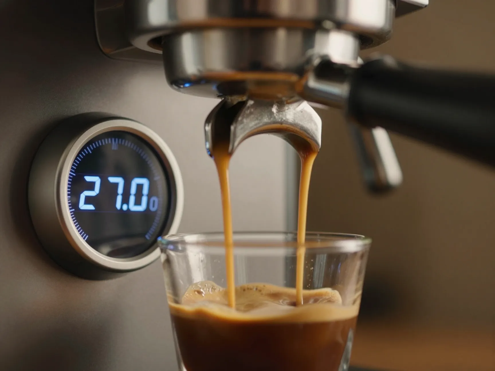 Shot timer at 27 seconds as espresso pours into clear glass