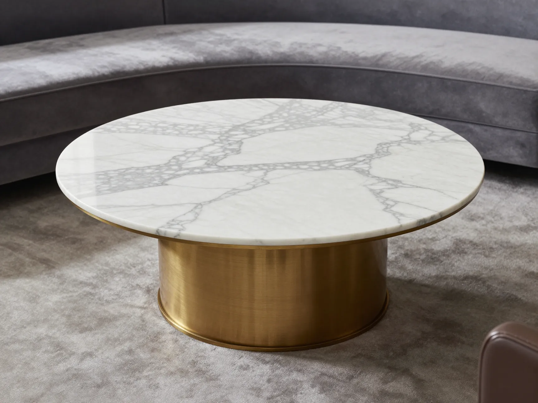 Round carrara marble top coffee table with brass base in executive suite