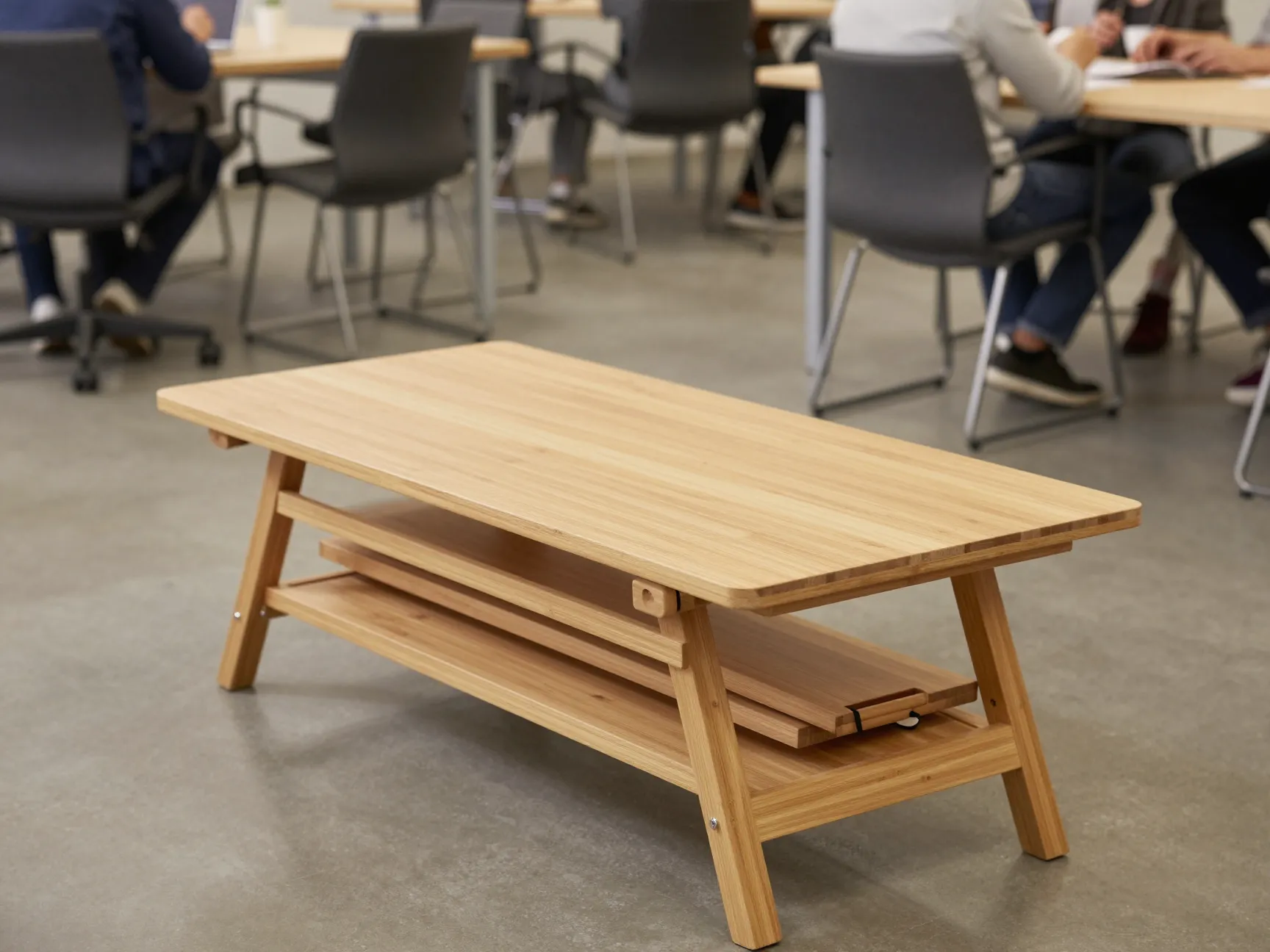 Foldable bamboo coffee table with carrying handle in flexible coworking space