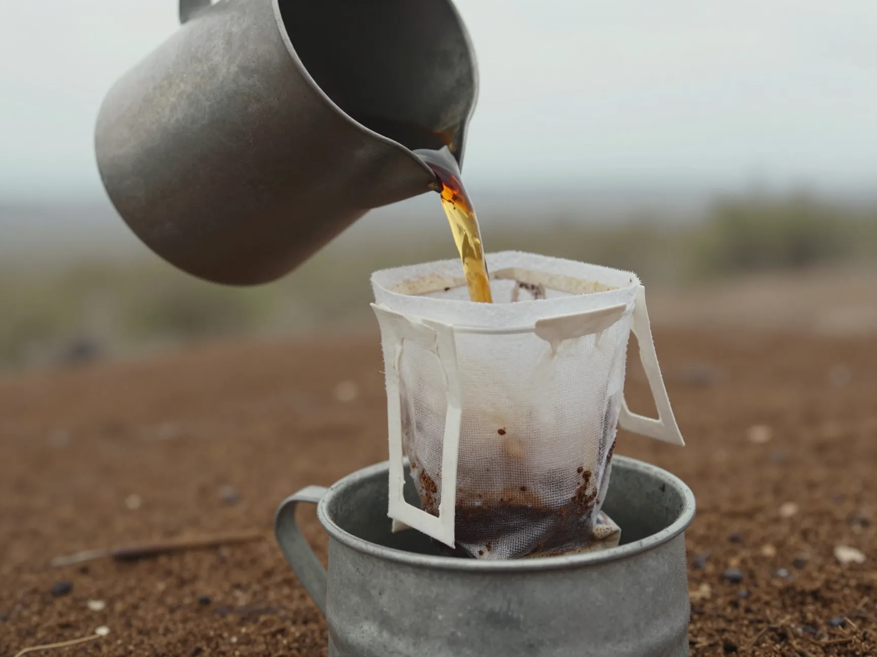 Clean cotton sock filtering coffee from pot to second container