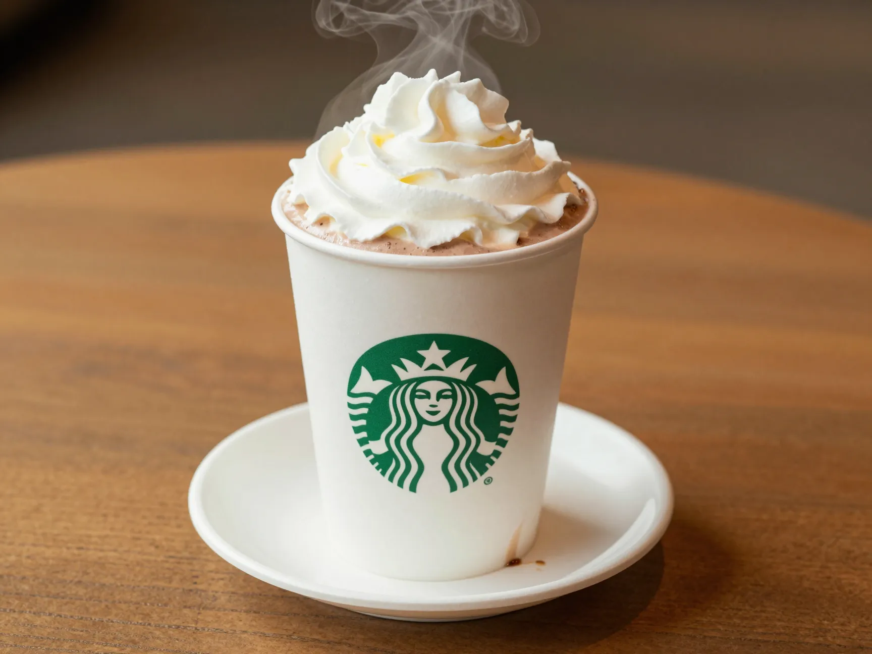 Hot grande white chocolate mocha with whipped cream on wooden table