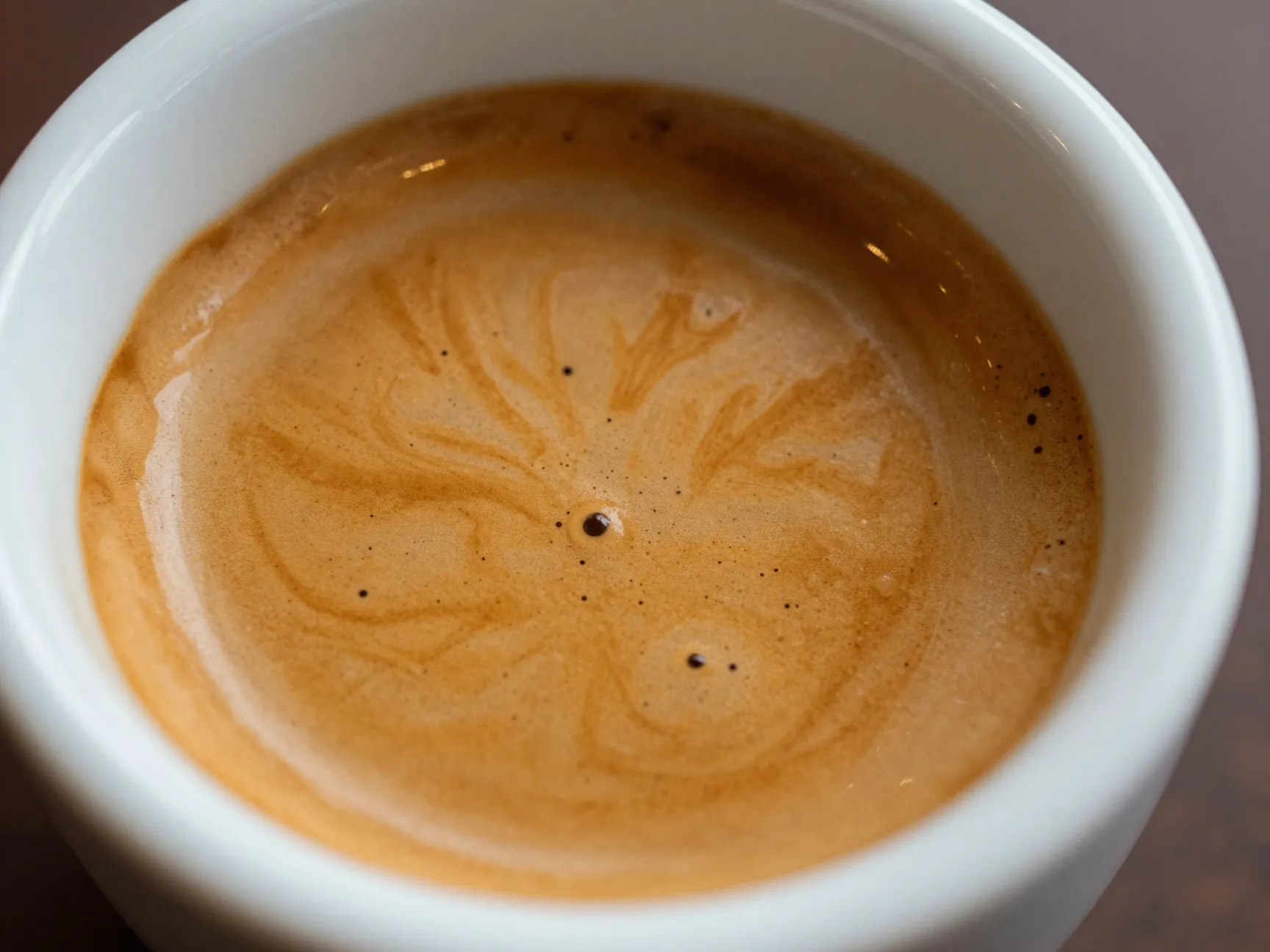 Fresh espresso with golden brown crema in ceramic cup