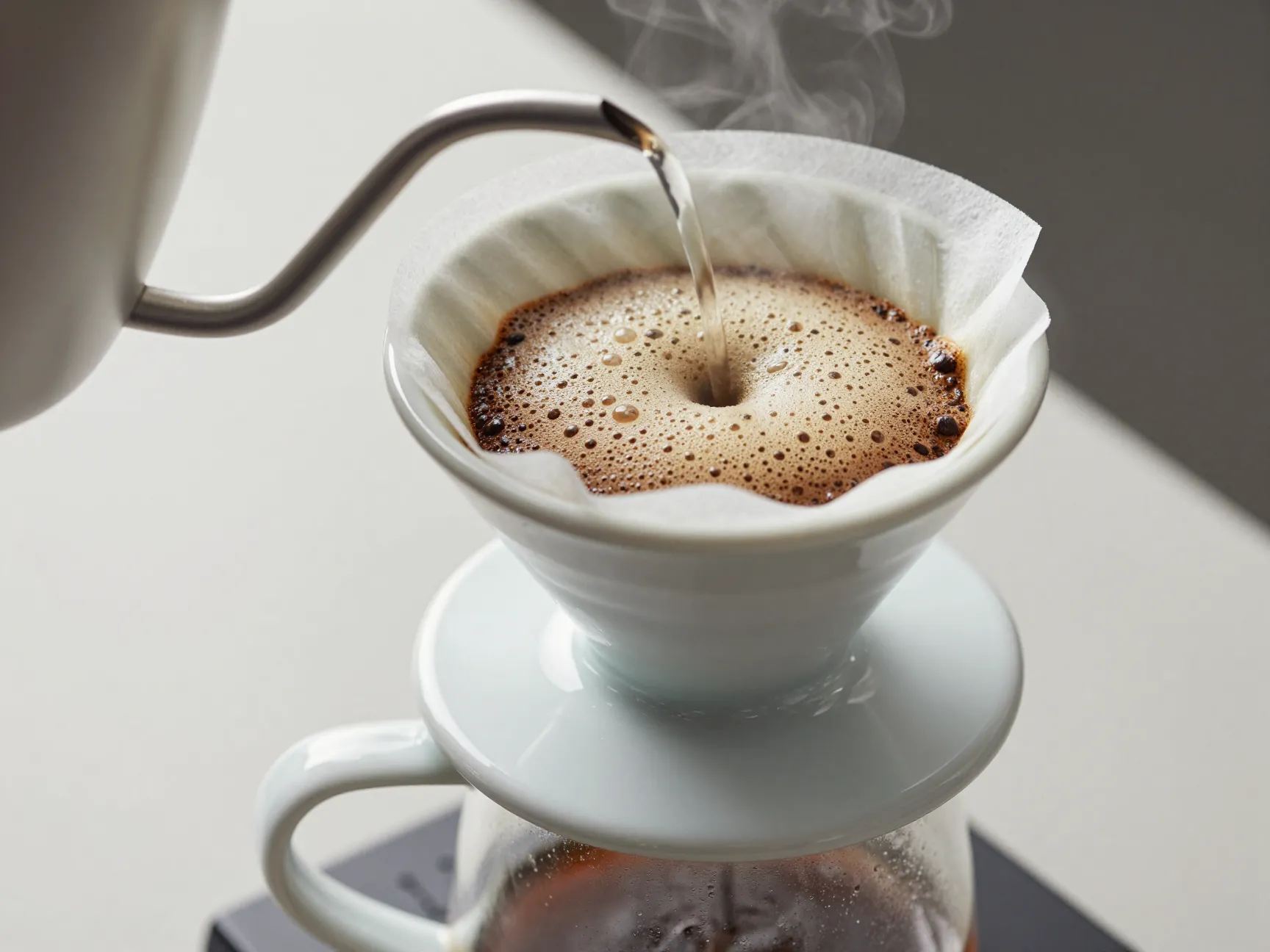 Pour over coffee dripper with blooming coffee grounds in filter
