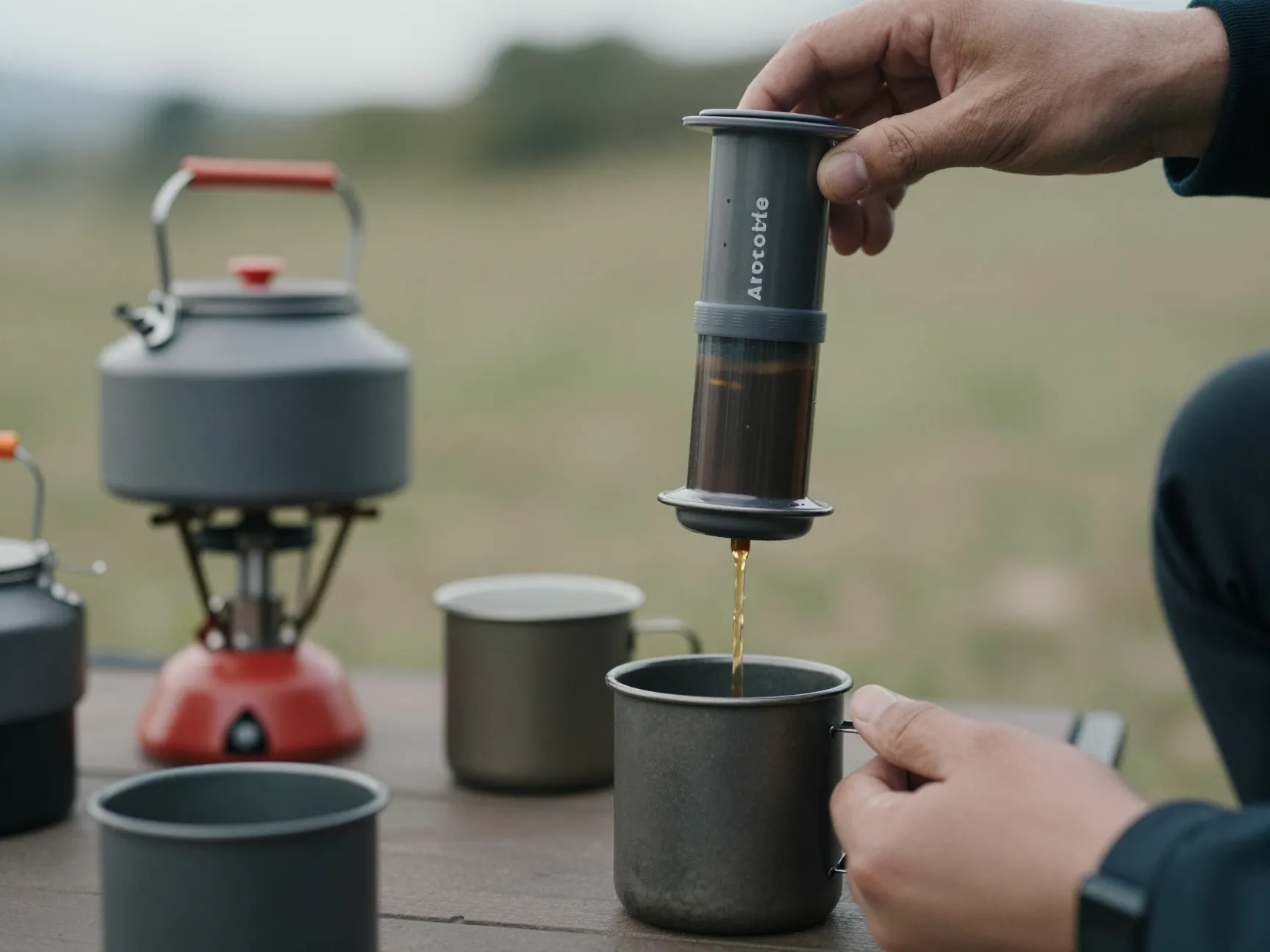 Aeropress being pressed over a camping mug in a travel setting