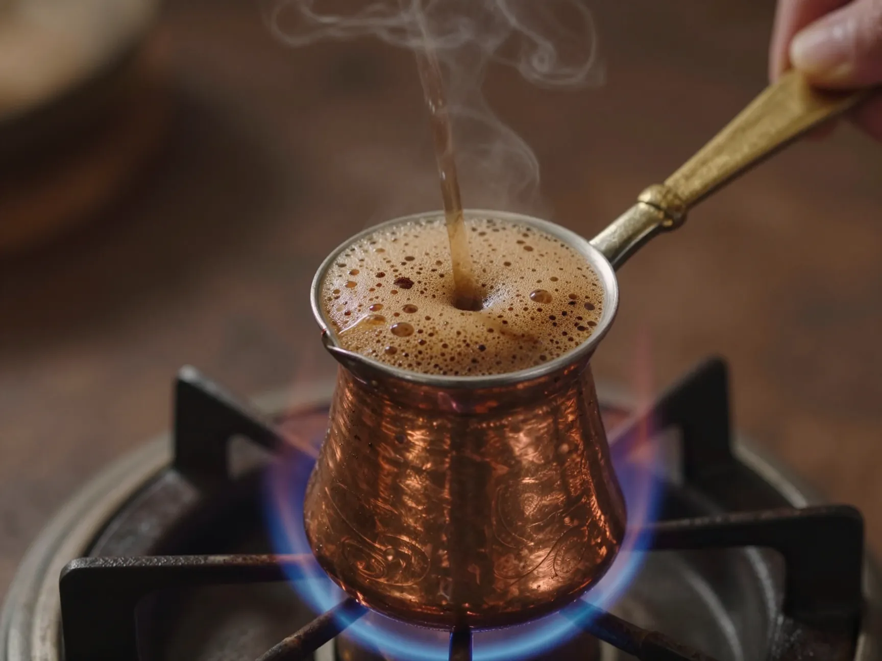 Traditional turkish cezve brewing on a low flame with foam