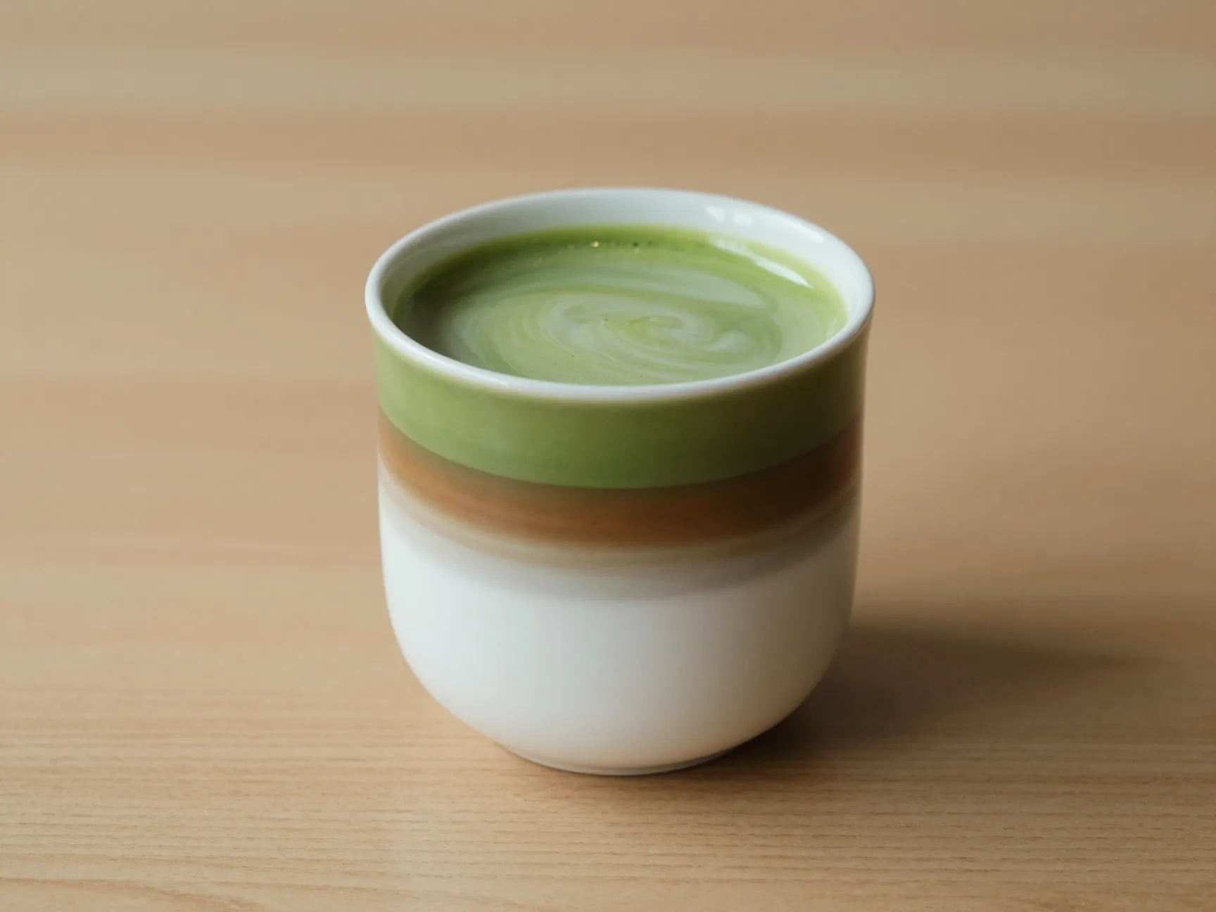 Matcha espresso fusion in ceramic cup with layered colors
