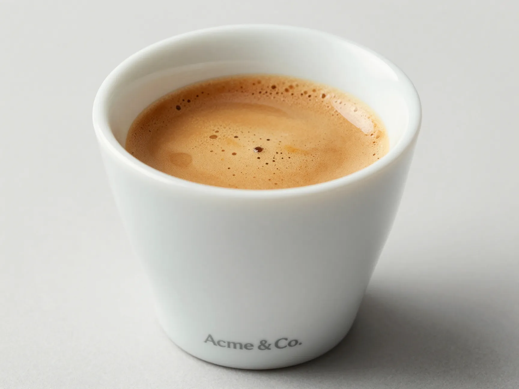 A tulip shaped espresso cup highlighting aroma and crema presentation