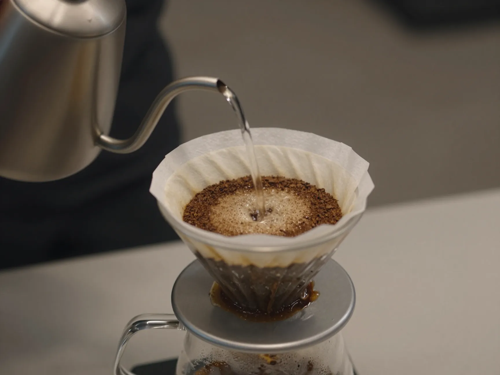Pour over technique with steady circular water pour onto coffee bed