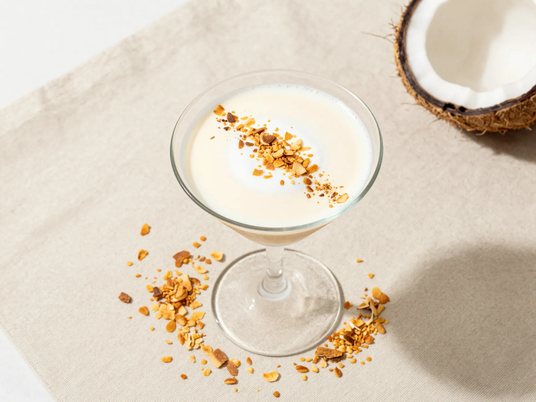 Coconut creamy espresso martini with toasted coconut flakes