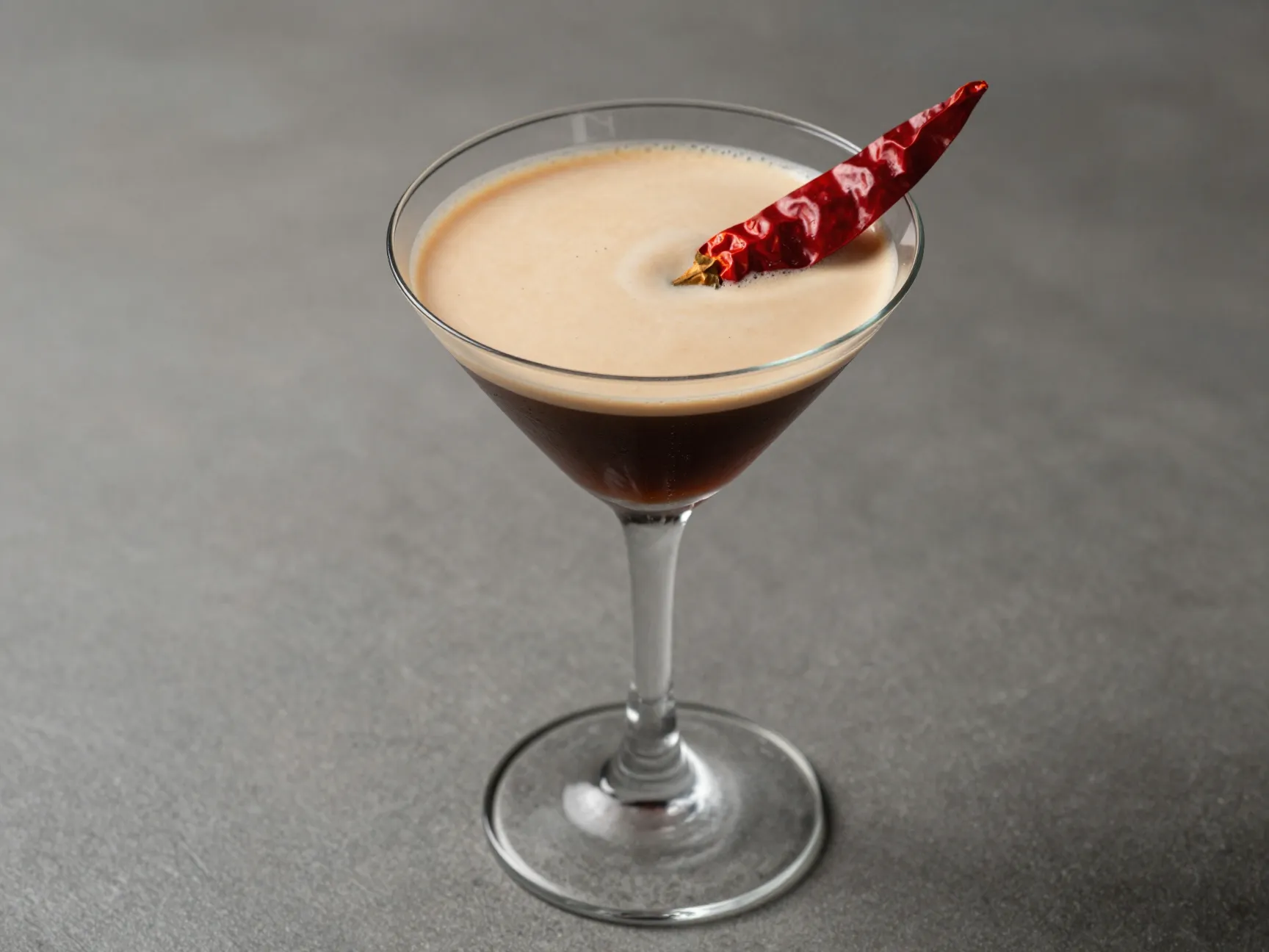 Spicy creamy espresso martini with dried chili garnish