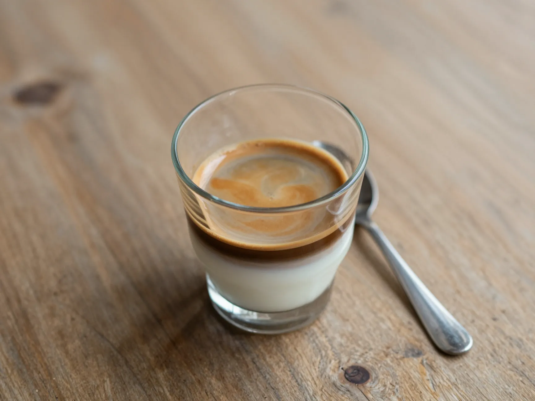 Cortado espresso cut with equal warm milk in small glass