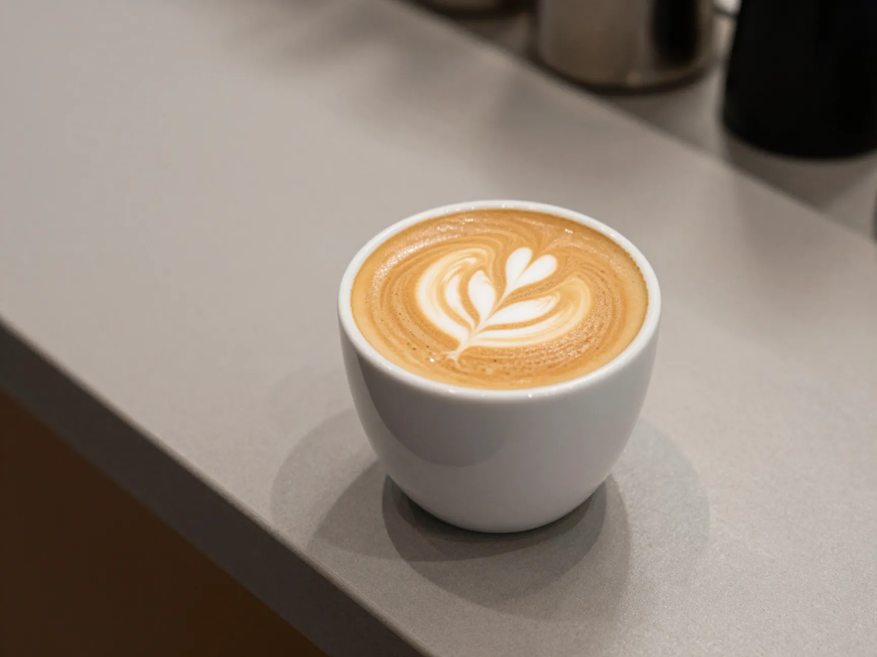 Flat white with velvety microfoam in small ceramic cup