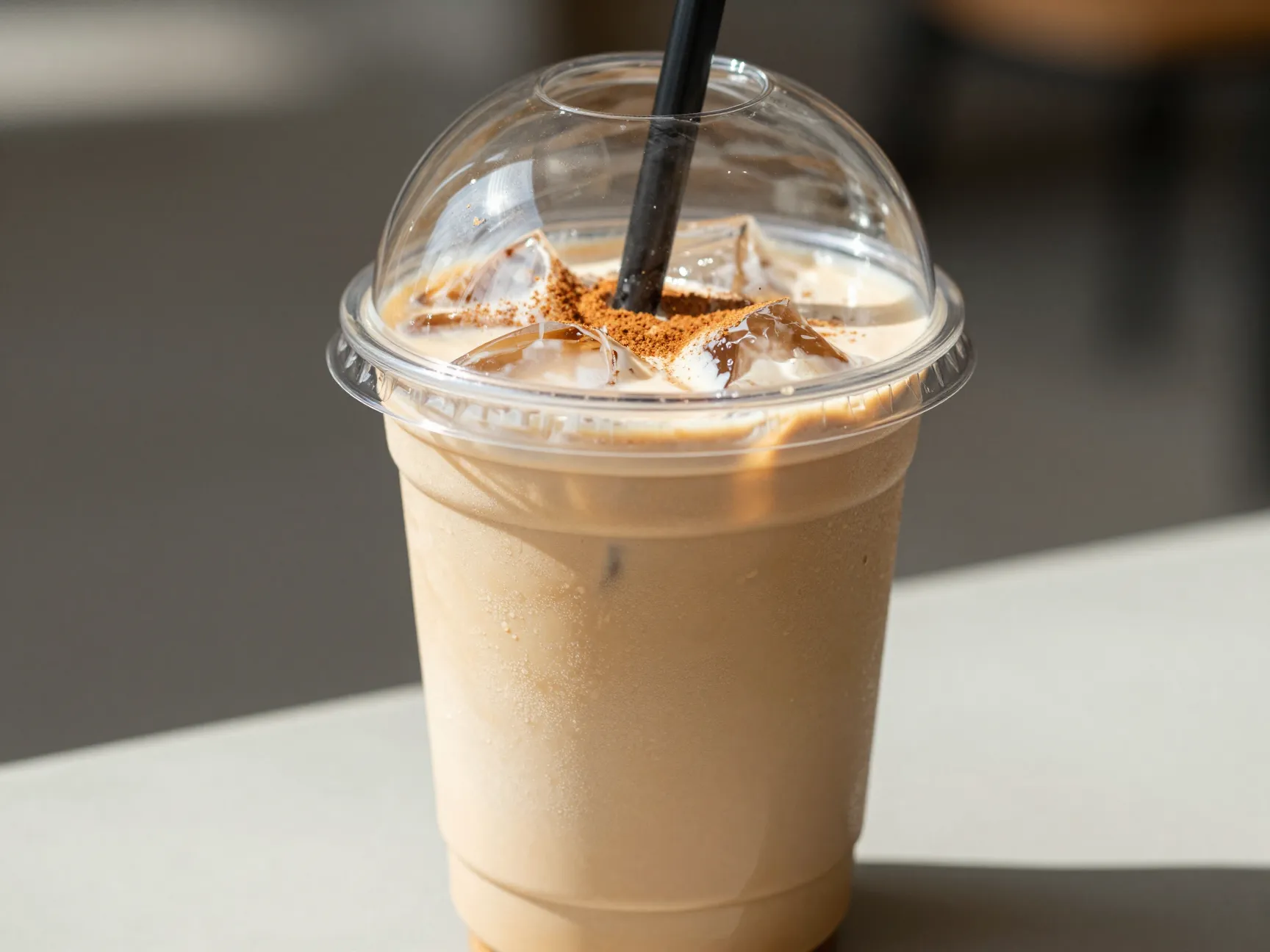 Frosted clear cup iced shaken espresso with brown oat milk and cinnamon