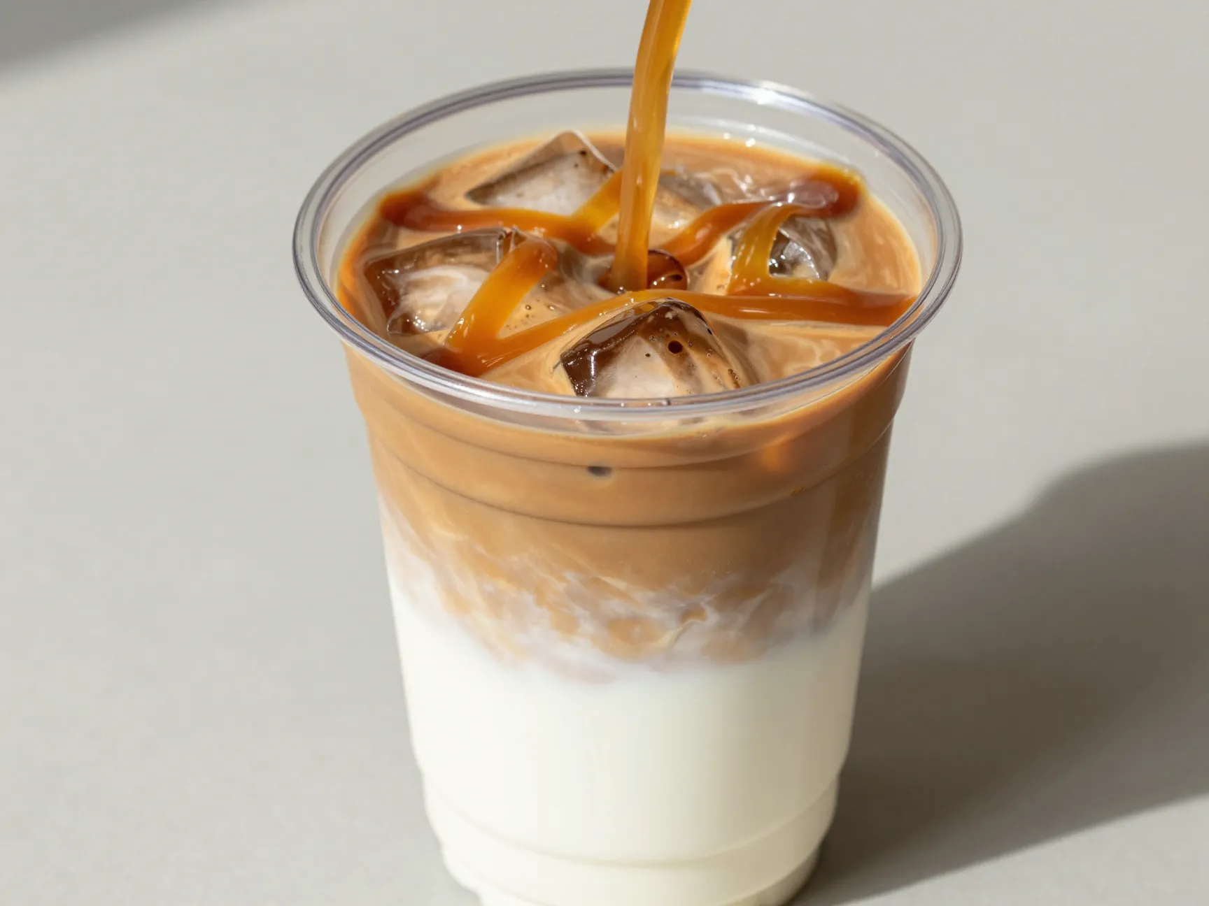 White mocha iced caramel macchiato with extra drizzle inside cup