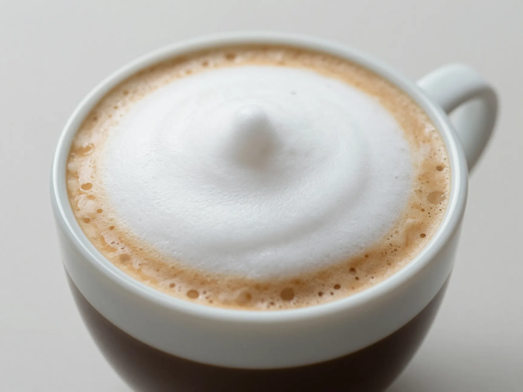 Traditional small ceramic cappuccino cup with equal layered parts