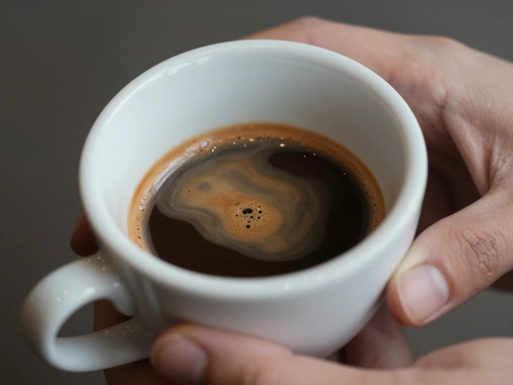 Strong dark espresso visible through a small cappuccino foam layer