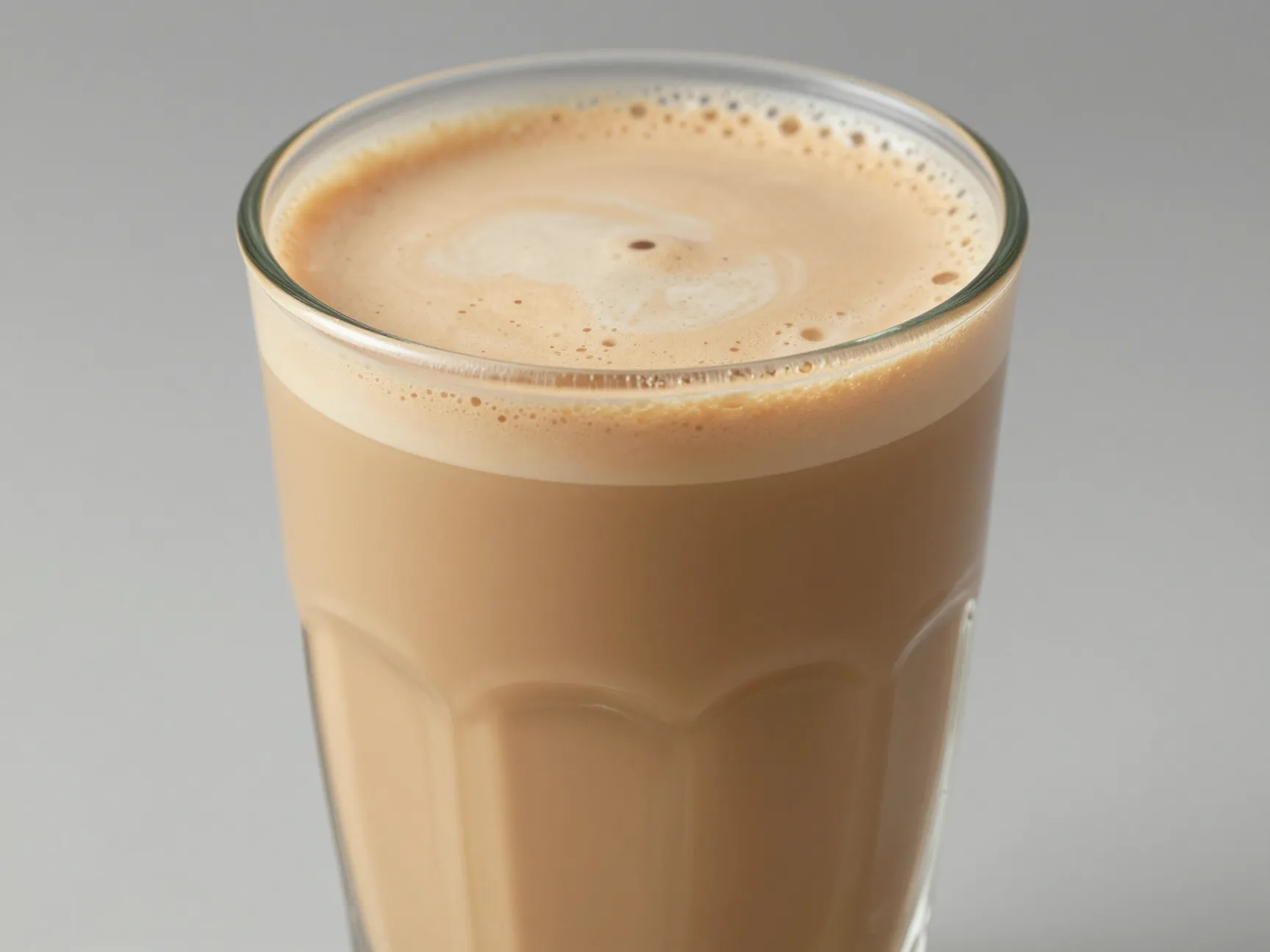 Large latte glass with creamy sweet light brown uniform liquid
