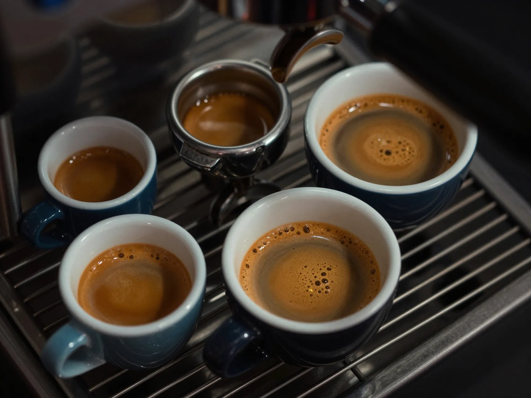 Two espresso shots pulled into small and large cups